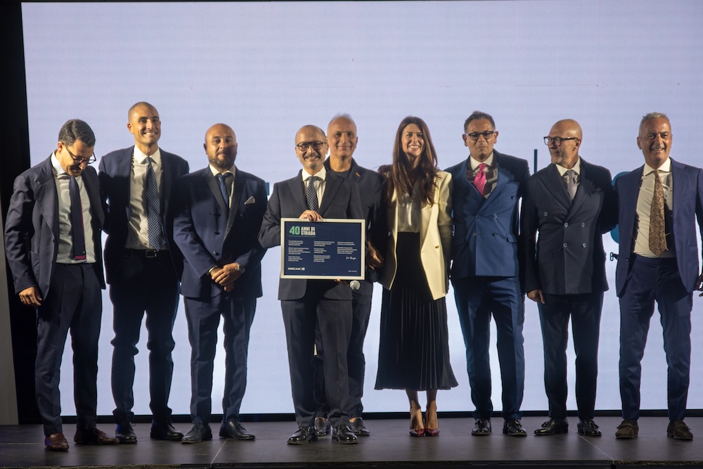 Un gruppo numeroso sul palco con la targa dei 40 anni